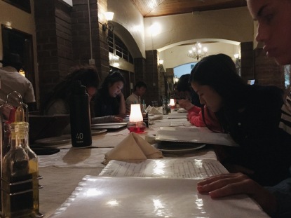 The team stares pensively at their menus